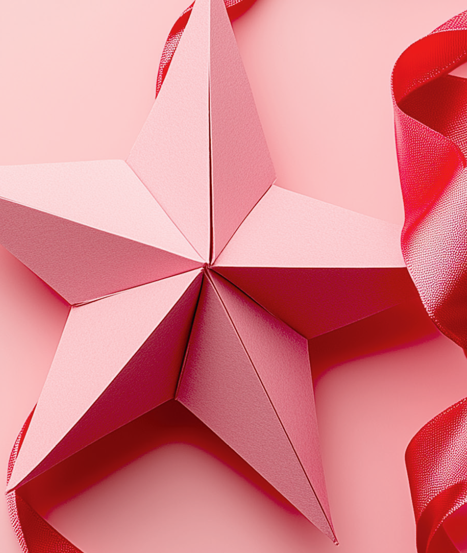 Pappersstjärna i rosa med röd dekorationsband, placerad på en rosa bakgrund